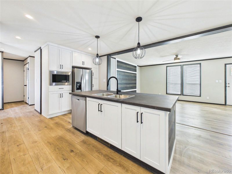 Kitchen (Wide View) – Well-designed kitchen layout with generous cabinetry, stainless steel appliances, and easy flow to adjacent spaces.