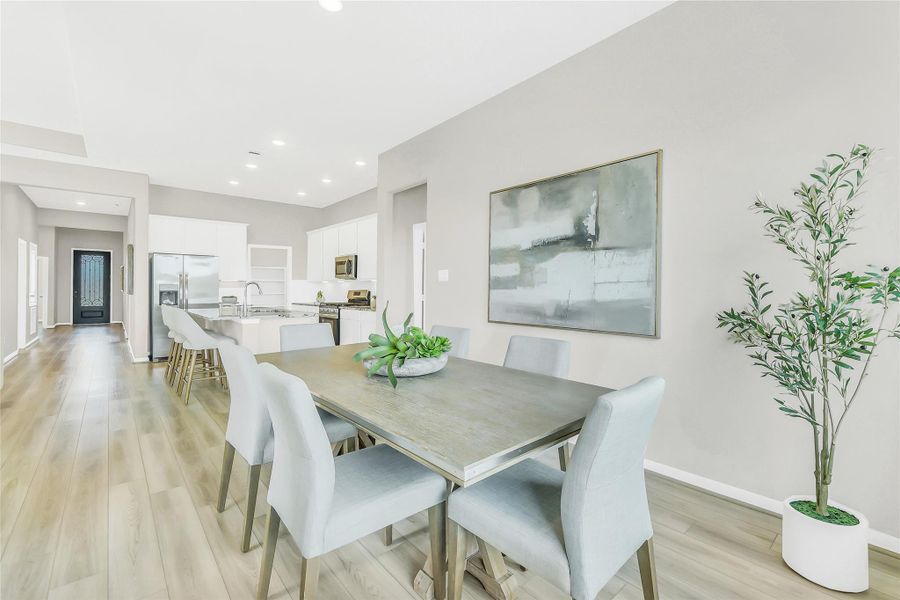 View from the dining area toward the kitchen and foyer, showcasing the home's wide-open architectural design.