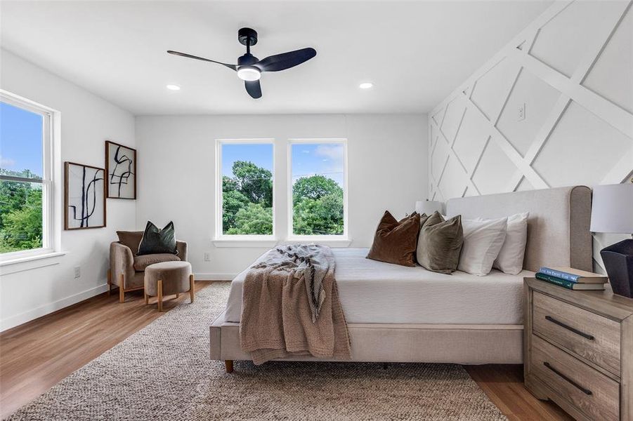 Bedroom with wood finished floors, a ceiling fan, and recessed lighting Bedroom with wood finished floors, a ceiling fan, and recessed lighting