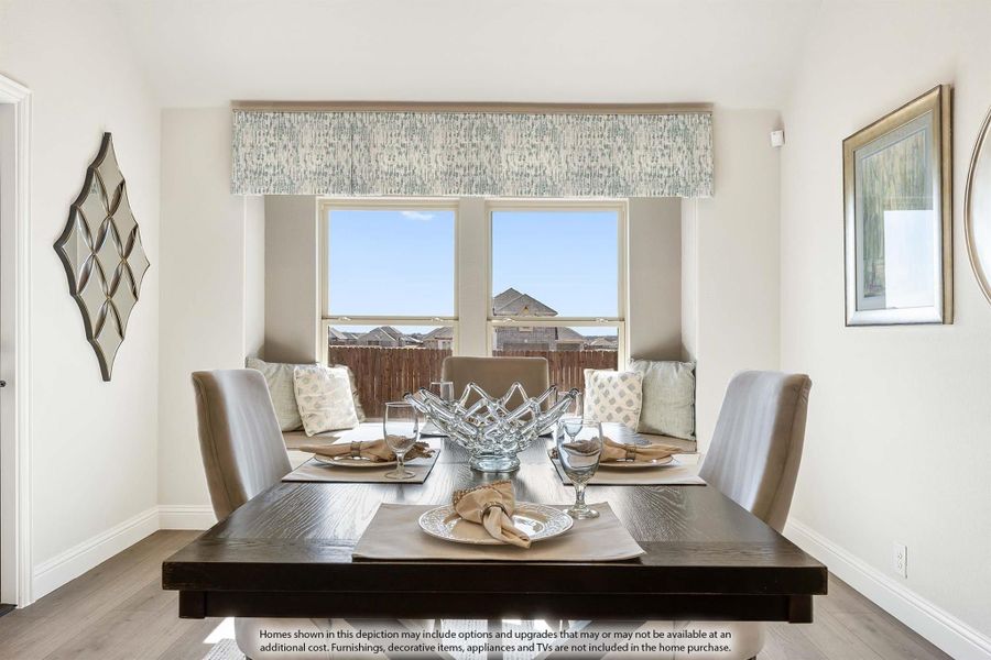 Dining room with dark wood table, upholstered chairs, and large window with neighborhood view Dining room with dark wood table, upholstered chairs, and large window with neighborhood view