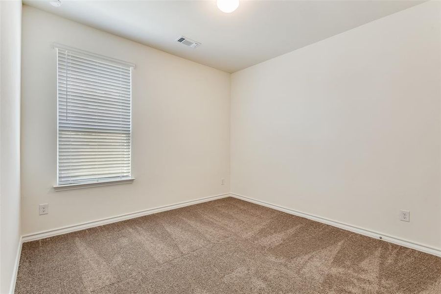 Empty room with carpet floors and baseboards Empty room with carpet floors and baseboards