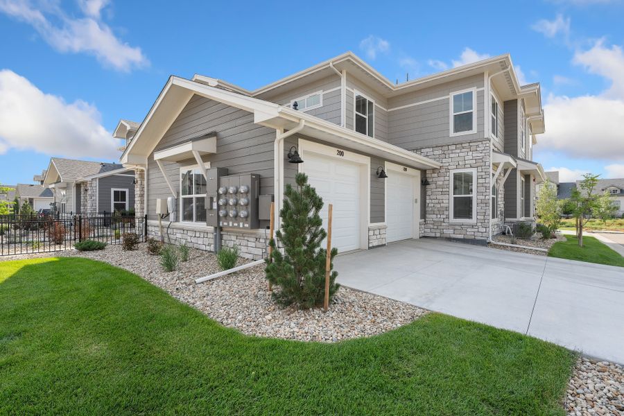 Front exterior of a new home in The Lakes at Centerra, Loveland, CO, highlighting curb appeal (Image 2).