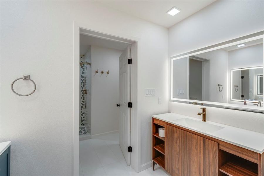 Bathroom featuring a shower with curtain and vanity