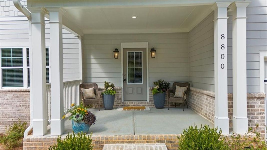 Exterior details and patio area of a home in River Rock, Ball Ground (Image 26).