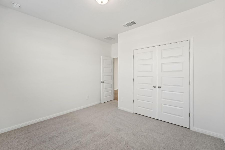 Unfurnished bedroom featuring carpet flooring and a closet