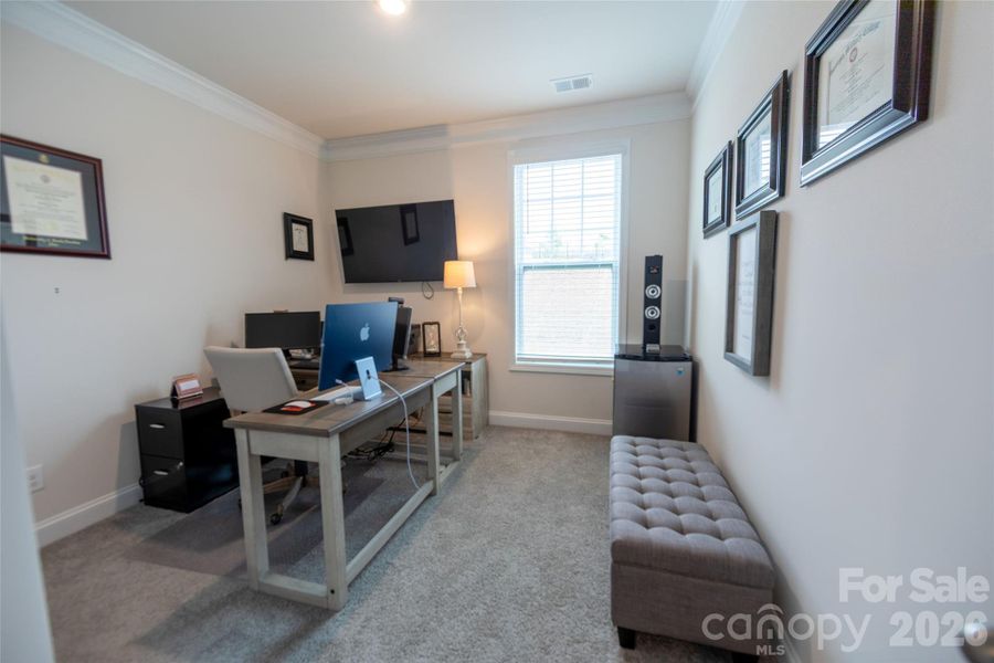 Main-level bedroom currently utilized as a home office.