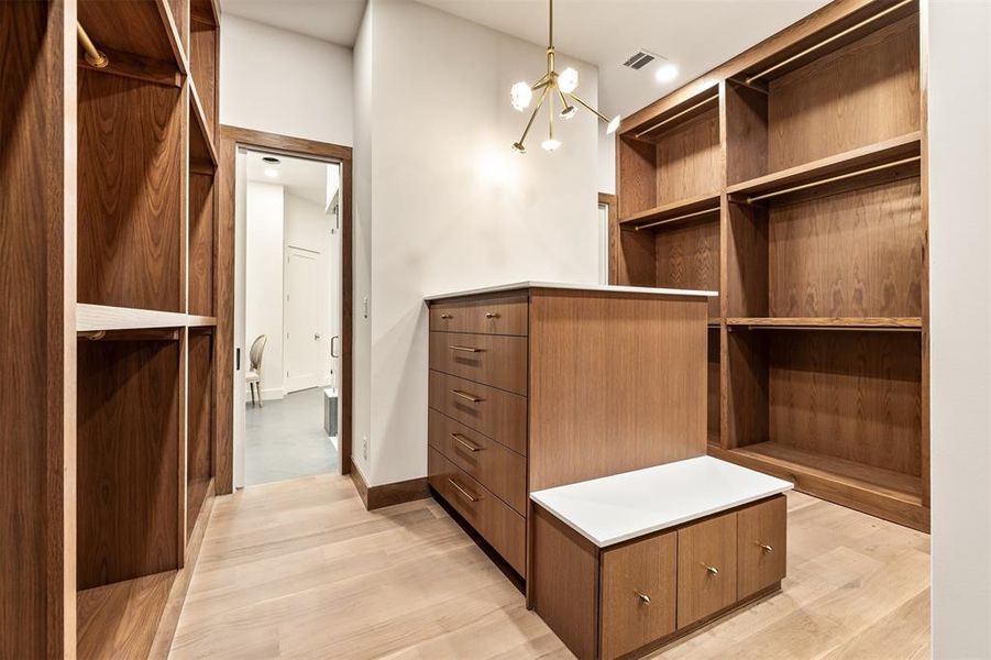 Generous hanging space and shelving make the closet feel as polished and well planned as the rest of the home