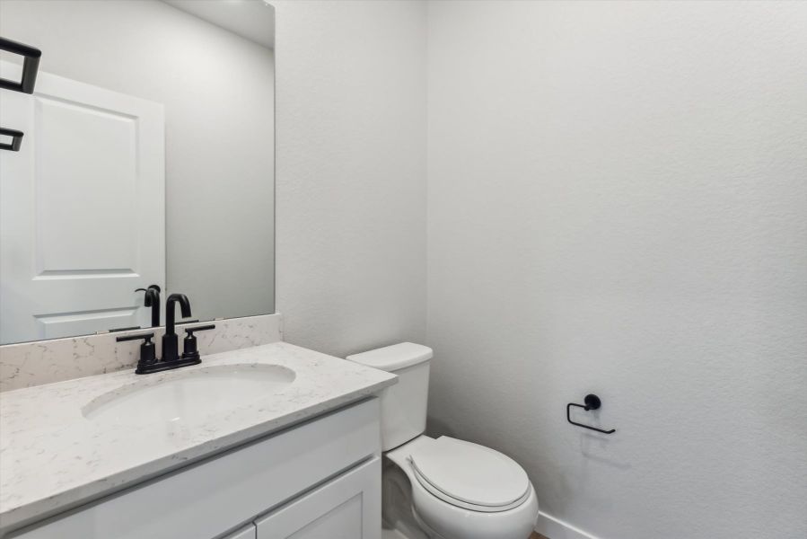 A bathroom with a toilet and sink.