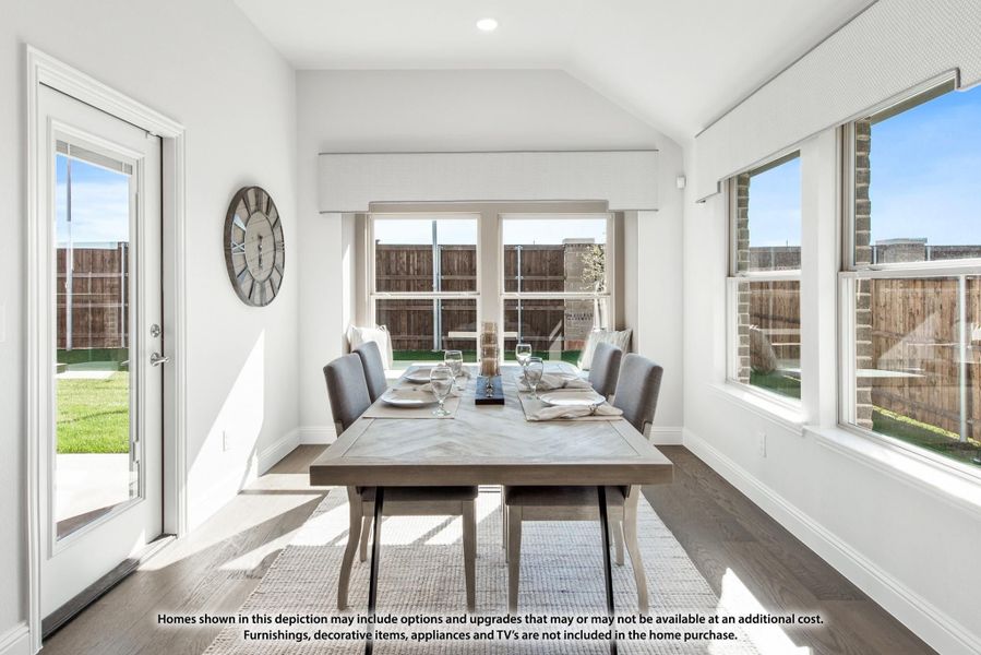 Bright dining room with vaulted ceiling, large windows, hardwood floors, and a six-seat dining table Bright dining room with vaulted ceiling, large windows, hardwood floors, and a six-seat dining table