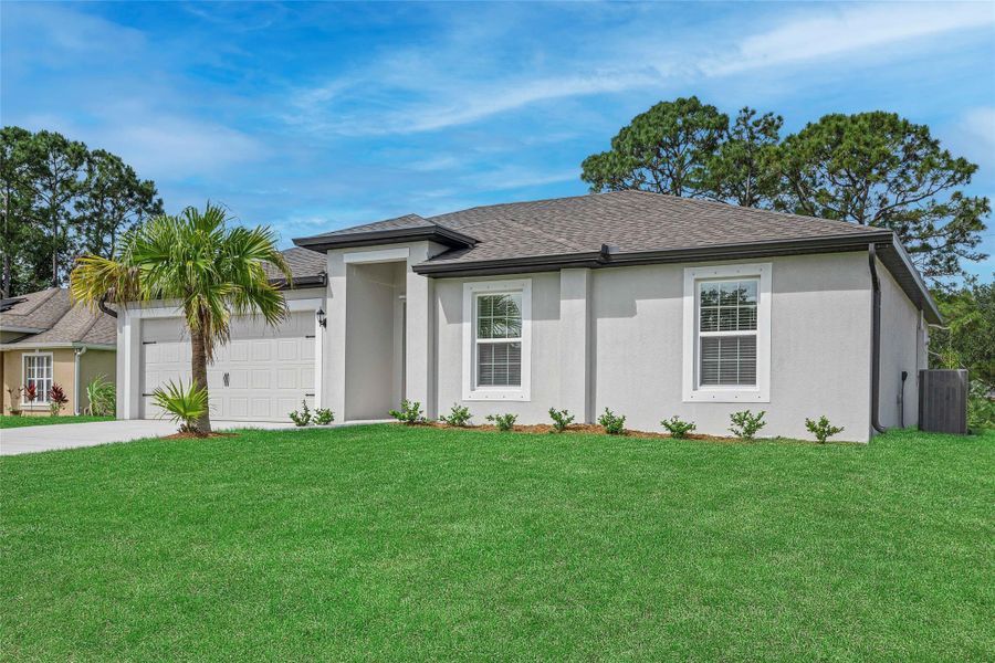 Front exterior of a new home in Vero Lake Estates, Vero Beach, FL, highlighting curb appeal (Image 1). Front exterior of a new home in Vero Lake Estates, Vero Beach, FL, highlighting curb appeal (Image 1).
