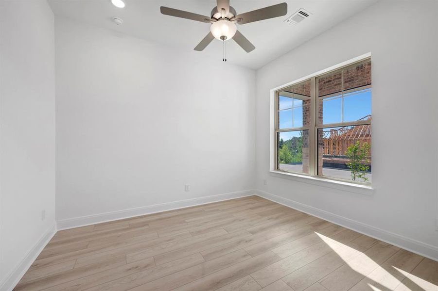Empty room featuring light wood finished floors, ceiling fan, and recessed lighting Empty room featuring light wood finished floors, ceiling fan, and recessed lighting
