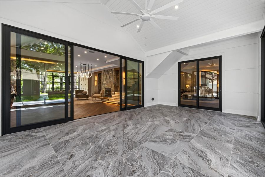 Expansive indoor-outdoor living space features walls of glass and effortless access to the backyard.