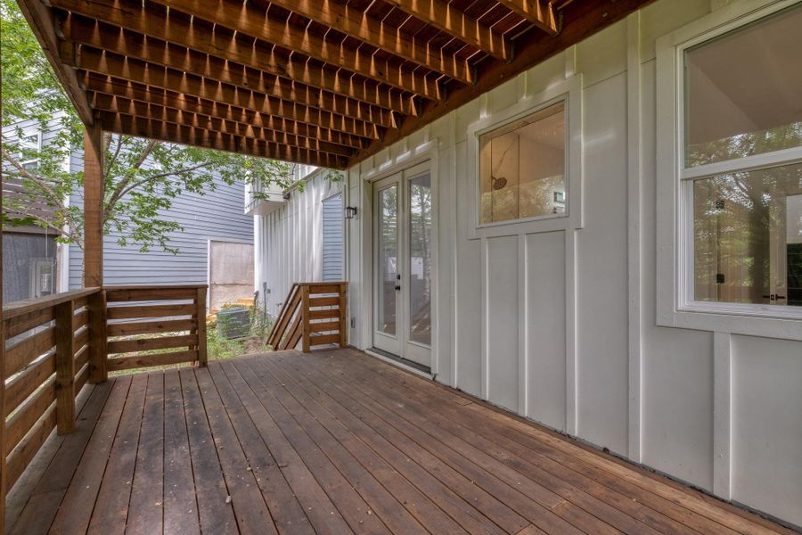 A spacious wooden deck provides ample outdoor living beneath a finished ceiling and board-and-batten siding. A spacious wooden deck provides ample outdoor living beneath a finished ceiling and board-and-batten siding.