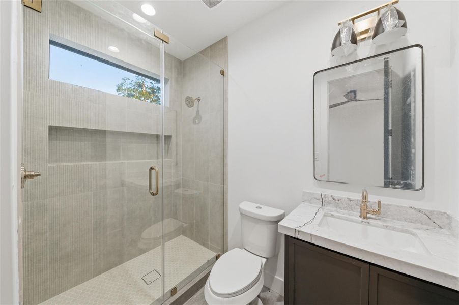 Beautifully finished secondary bathrooms feature modern fixtures, designer touches, and a clean, timeless aesthetic.