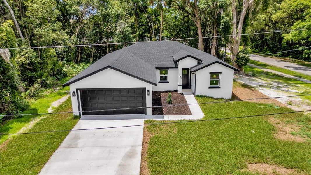Front exterior of a new home in , Orange City, FL, highlighting curb appeal (Image 1). Front exterior of a new home in , Orange City, FL, highlighting curb appeal (Image 1).