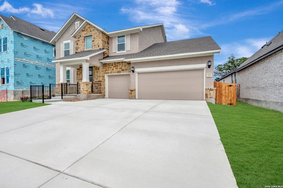Front exterior of a new home in Davis Ranch 60', San Antonio, TX, highlighting curb appeal (Image 25). Front exterior of a new home in Davis Ranch 60', San Antonio, TX, highlighting curb appeal (Image 25).