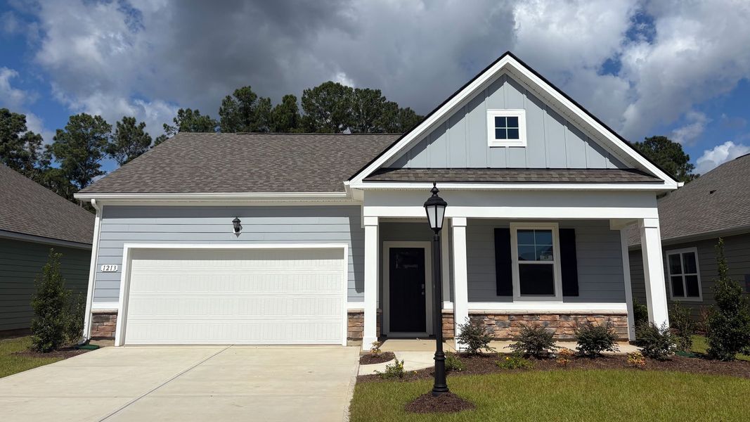 Front exterior of a new home in Rich Square at Brunswick Plantation, Ash, NC, highlighting curb appeal (Image 1).