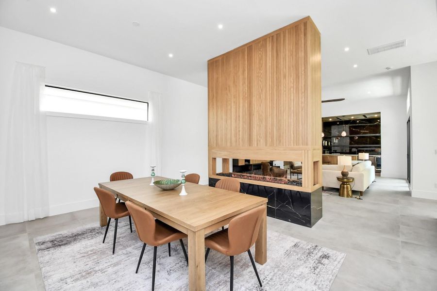 Dining room is separated by a custom built electric fireplace. Dining room is separated by a custom built electric fireplace.