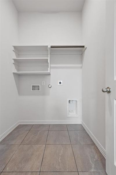 Laundry area with hookup for a gas dryer, hookup for a washing machine, hookup for an electric dryer, and light tile patterned floors