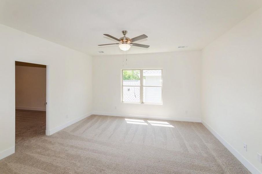 Unfurnished room with ceiling fan and light carpet