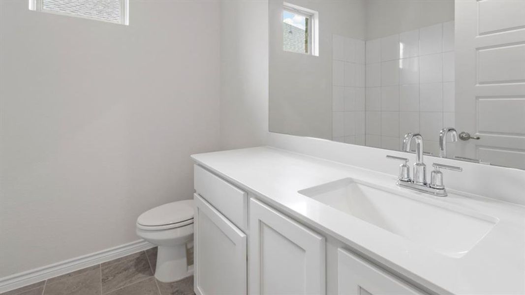 Bathroom with vanity and baseboards