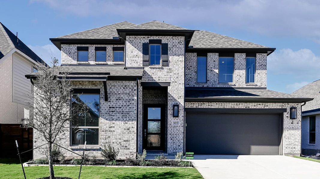 Front exterior of a new home in Juniper Springs, Lockhart, TX, highlighting curb appeal (Image 22).