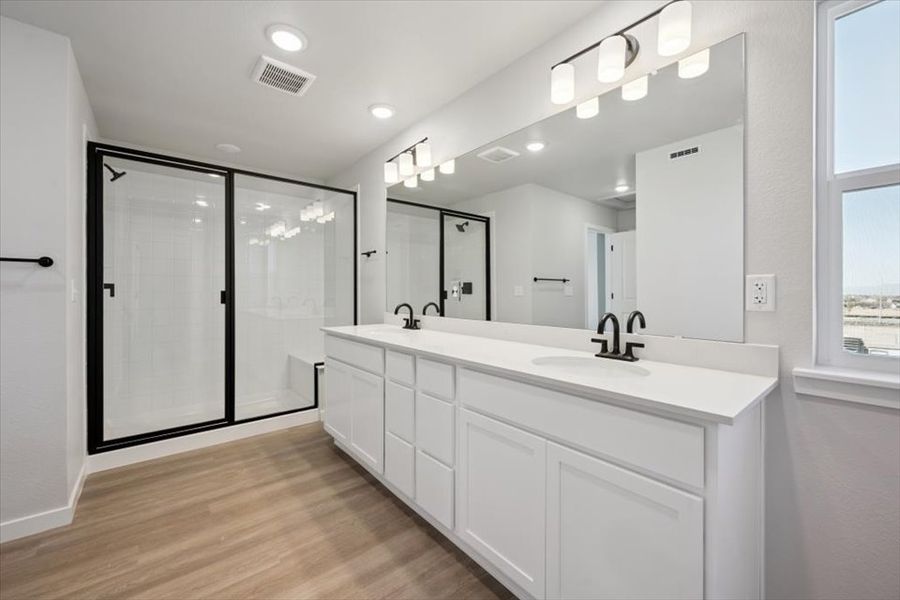 A bathroom with a large mirror. A bathroom with a large mirror.