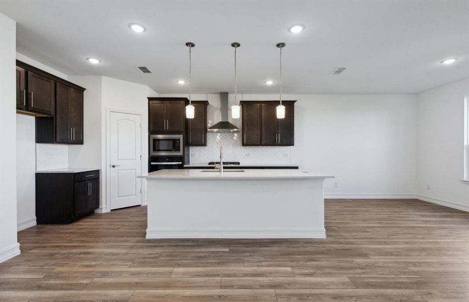 Expansive kitchen with oversized island *real home pictured