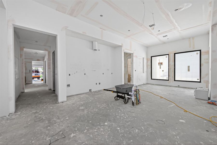 Kitchen will feature Thermador appliances, stained white oak cabinets, and deco vent hood. Hallway leads to pantry, guest suite and utility room