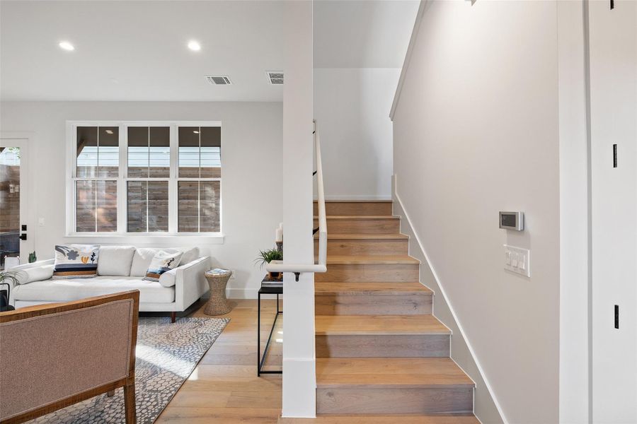 Stairs featuring hardwood / wood-style flooring