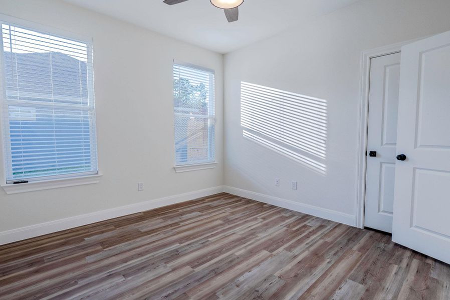 Unfurnished bedroom featuring light wood-style flooring and ceiling fan Unfurnished bedroom featuring light wood-style flooring and ceiling fan