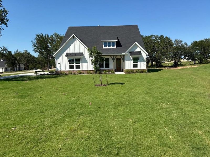 Front exterior of a new home in Oak Grove Addition, Springtown, TX, highlighting curb appeal (Image 21).