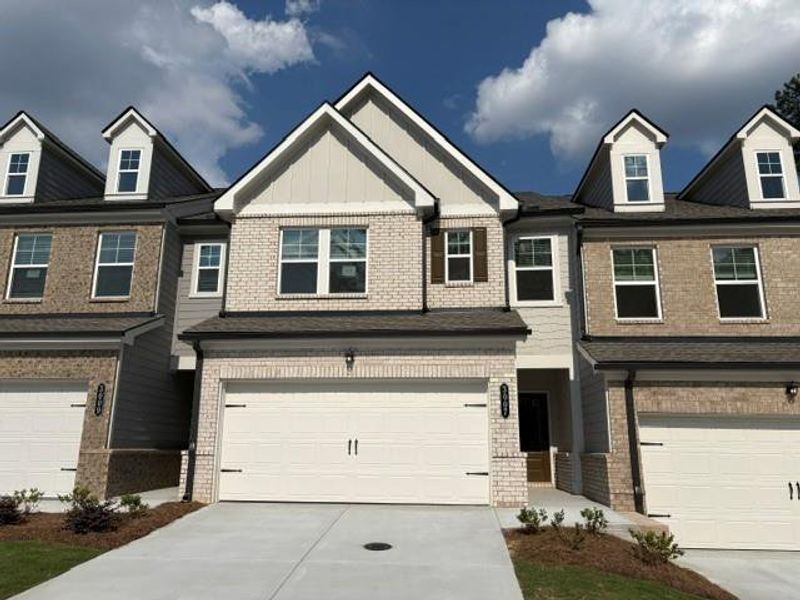 Front exterior of a new home in Towns at Ivy Creek, Buford, GA, highlighting curb appeal (Image 2). Front exterior of a new home in Towns at Ivy Creek, Buford, GA, highlighting curb appeal (Image 2).