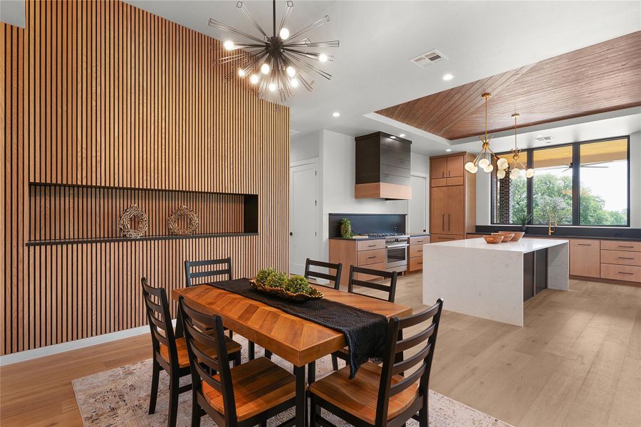 Dining area with a chandelier, light wood finished floors, and recessed lighting Dining area with a chandelier, light wood finished floors, and recessed lighting