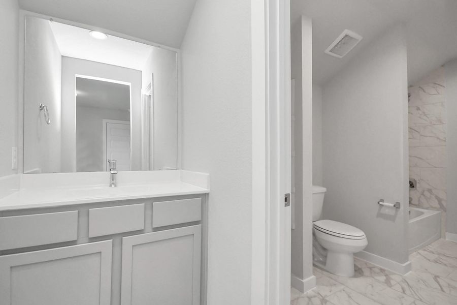 Experience convenience in the secondary bathroom, designed for Jack and Jill arrangements, now with a separate vanity area. Sample photo of completed home with same plan. Actual colors and selections may vary. Experience convenience in the secondary bathroom, designed for Jack and Jill arrangements, now with a separate vanity area. Sample photo of completed home with same plan. Actual colors and selections may vary.
