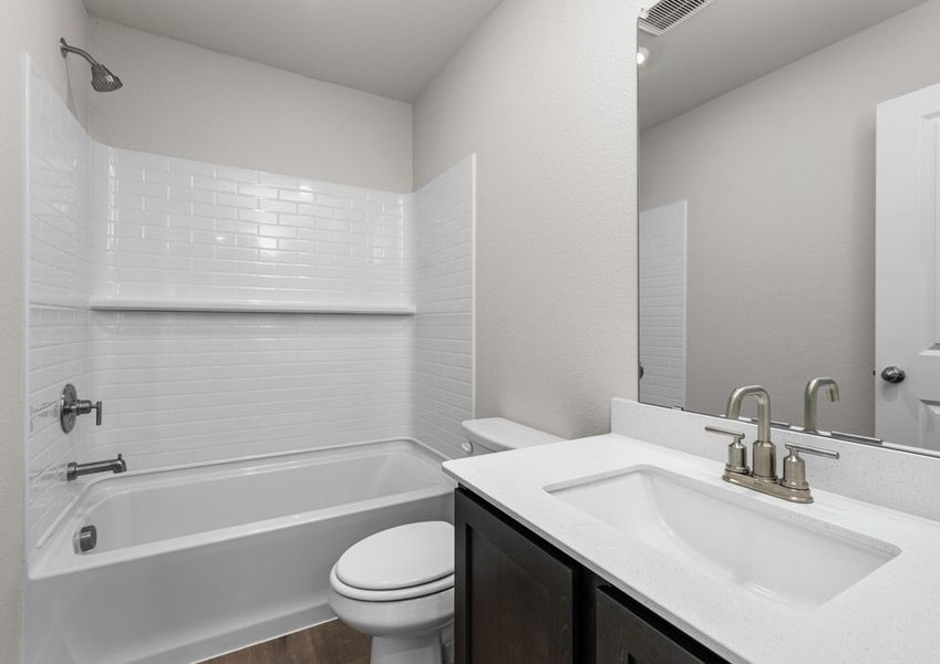 The secondary bathroom has a sprawling vanity and a shower-tub combo. The secondary bathroom has a sprawling vanity and a shower-tub combo.