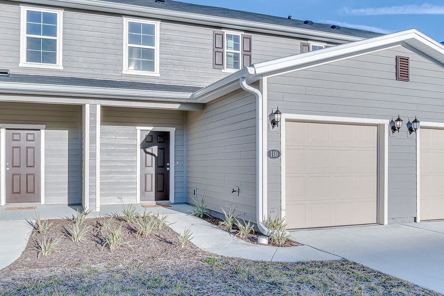 Front exterior of a home in the Orchard Park Townhomes community, located in St. Augustine, FL (Image 5).