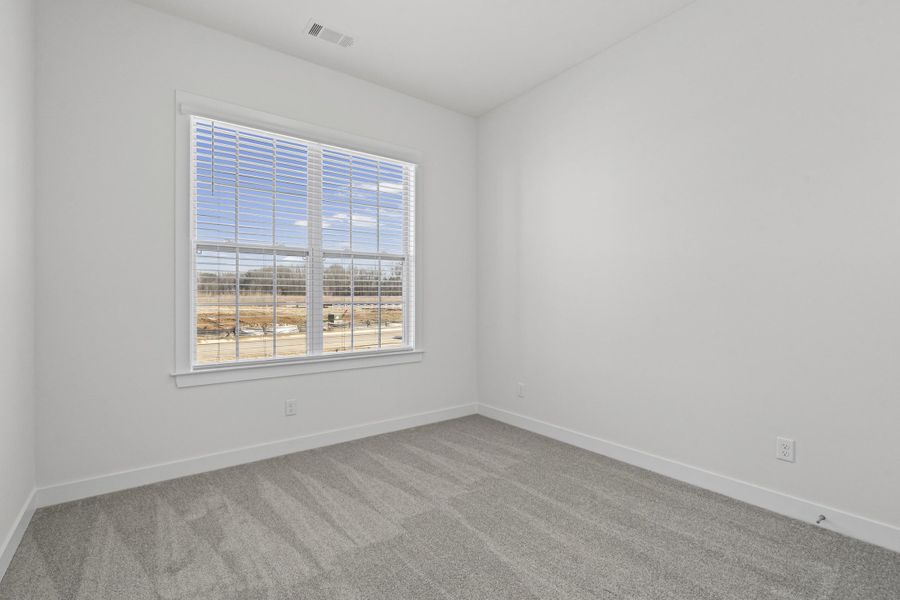Unfurnished room featuring carpet and baseboards