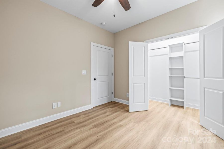 Bedroom 4 is located on the upper level and offers a large closet with built in shelving