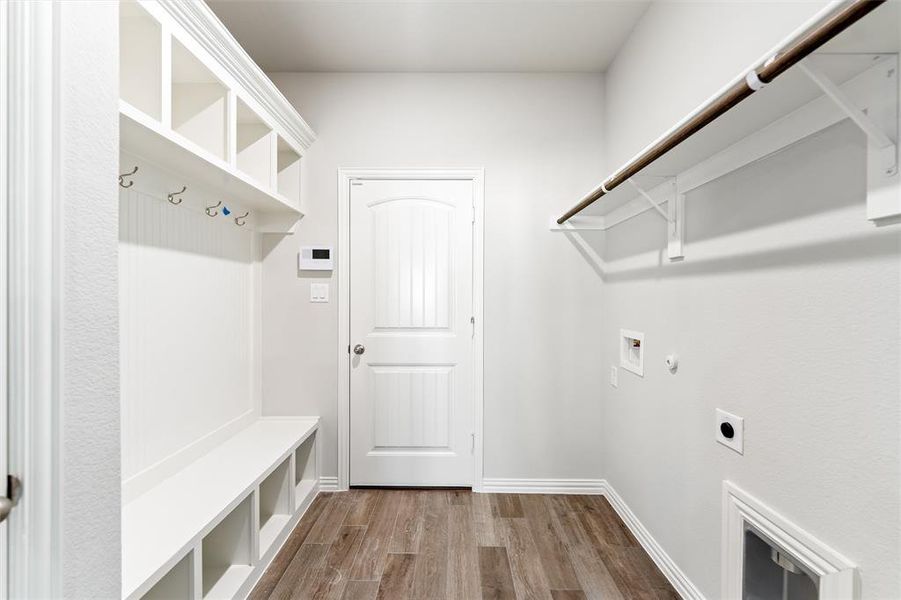 Laundry area with dark wood-style flooring, gas dryer hookup, electric dryer hookup, and hookup for a washing machine