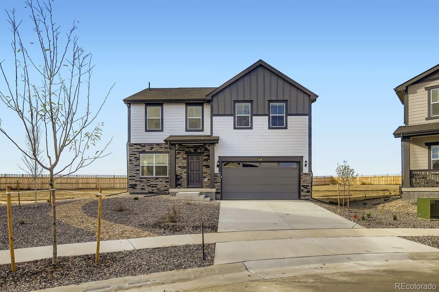 Front exterior of a new home in Ledge Rock: The Camden Collection, Johnstown, CO, highlighting curb appeal (Image 1).