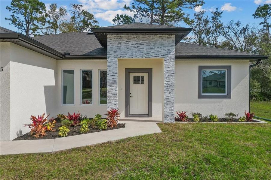 Front exterior of a new home in , Deltona, FL, highlighting curb appeal (Image 1). Front exterior of a new home in , Deltona, FL, highlighting curb appeal (Image 1).