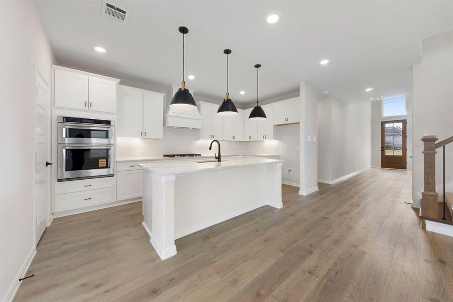 Featuring a spacious kitchen island that overlooks the family and dining rooms, the chef in the family will never be left out of the party in this dream kitchen!