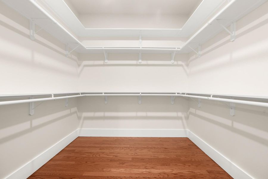 Ample shelving and hanging space defines this generously sized walk-in closet. Ample shelving and hanging space defines this generously sized walk-in closet.