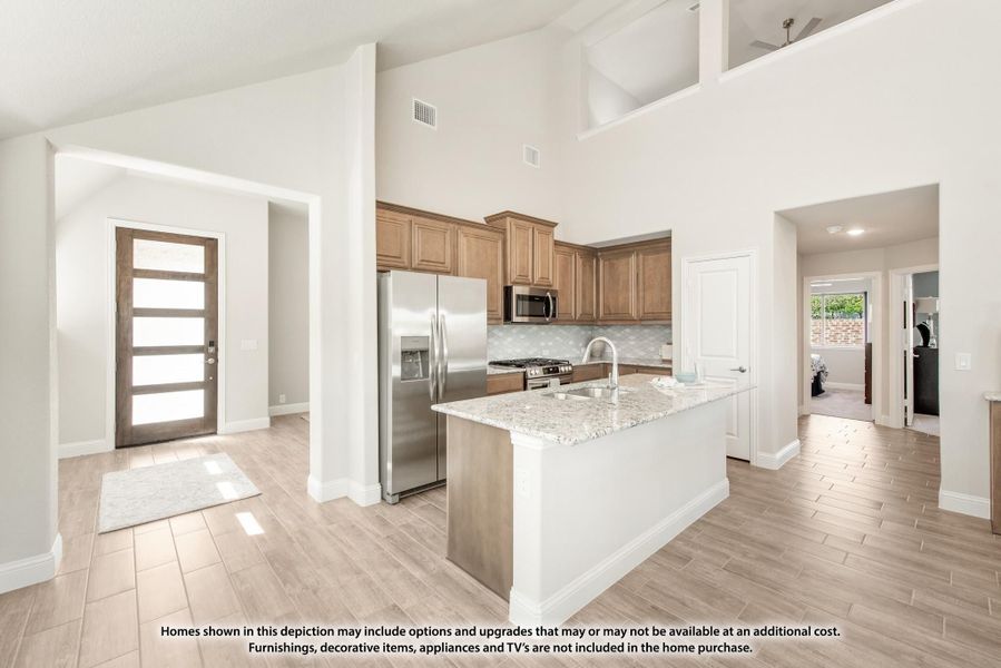 Open-concept kitchen with granite island, stainless steel appliances, wood cabinets, and high ceilings visible from entryway Open-concept kitchen with granite island, stainless steel appliances, wood cabinets, and high ceilings visible from entryway