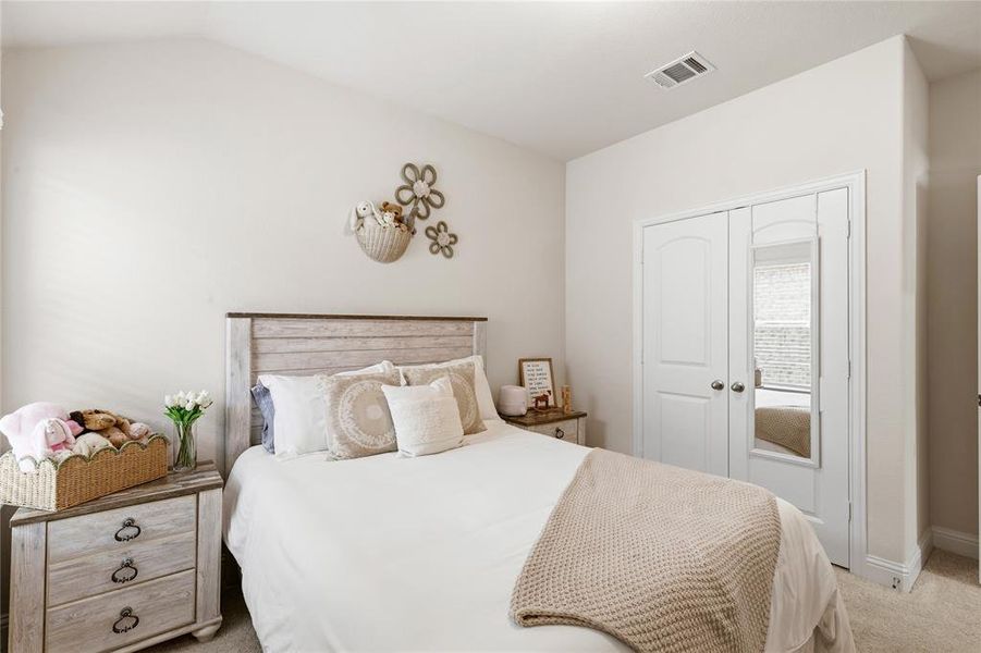 Bedroom featuring a vaulted ceiling and light neutral wall paint
