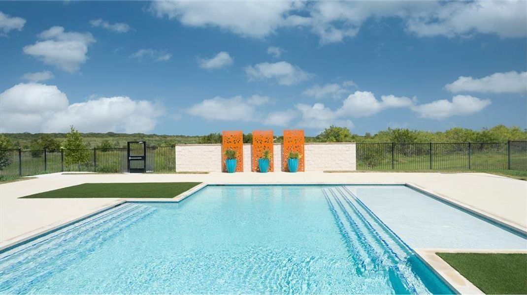 A pristine pool with modern orange accent panels offers a serene escape, framed by a clear blue sky. A pristine pool with modern orange accent panels offers a serene escape, framed by a clear blue sky.