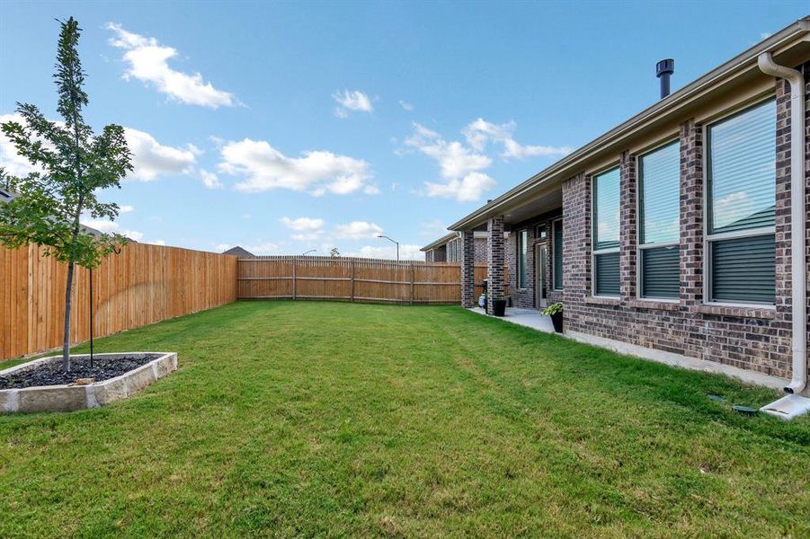 Fenced backyard with a patio area