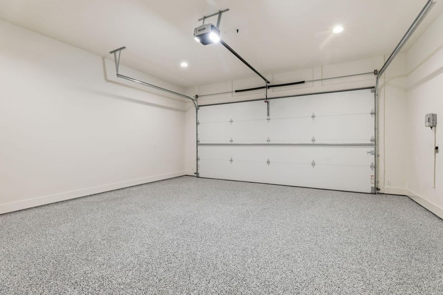 Garage with recessed lighting and a garage door opener