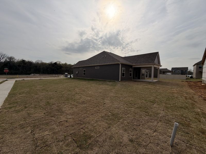 Showcasing the premium corner lot this home sits on w/ it`s extended covered back porch!